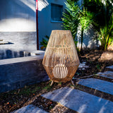 Sisine Floor Lamp - lit on a garden path