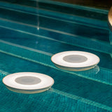 Wally Play Disk Floating Speaker Light - two units floating in a pool