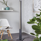 Spadafora Floor Lamp By Eglo - Black Color alongside chair