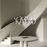 Collide Linear Pendant by Kuzco - Large, Black hanging above on round table