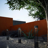 Knox Outdoor Bollard by Kuzco - Black, Fixed on the ground near tree