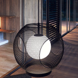 Kona Outdoor Pendant Light by Kuzco - Black/Opal Glass, Hanging over the couch