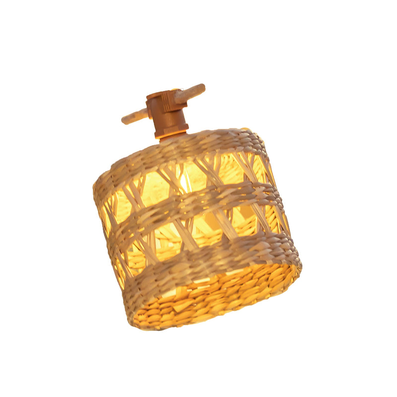 Small woven rattan lantern with a wooden toggle hanger glowing warmly from the bulb inside — Alba Solar-charged Garland by New Garden