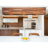 Aeris Linear Pendant by Cerno in walnut hanging above a modern kitchen island