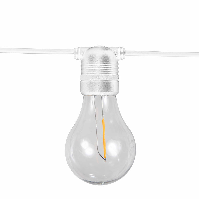 Clear A-shape filament bulb on a white cable string light glowing with a warm amber filament — Allegra Solar-charged Garland by New Garden