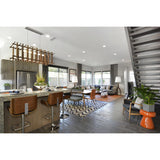 Arca Linear Pendant by Cerno in walnut above a kitchen island in an open living space