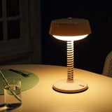 Bellboy Table Lamp - Jet Blue, lit on a dining table