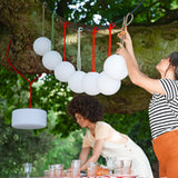 Bolleke Hanging Lamp - Red, hung over a garden table