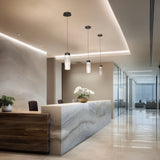 Black/White Glass Kanister Pendant by WAC Lighting in Reception Area