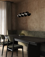 Black Void Linear Pendant by Kuzco Lighting in Dining Area