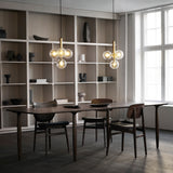 Brass/Optic Clear Miira 4 Pendant Light by Nuura in Dining Area