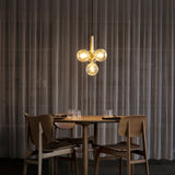 Brass/Optic Clear Miira 4 Pendant Light by Nuura in Dining Area