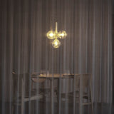 Brass/Optic Clear Miira 4 Pendant Light by Nuura in Dining Area
