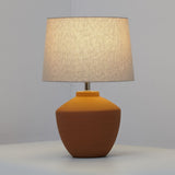 Buriti Table Lamp by Geo Contemporary in Terracotta with a Rustic Linen shade, lit