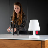 Edison The Petit Table Lamp - White, on a kitchen island