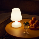 Edison The Petit Table Lamp - White, lit on a dining table