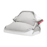 Light grey and white floating bean bag with adjustable straps, buckles, and a red Fatboy tab — Floatzac by Fatboy