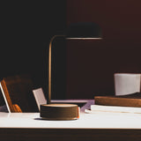 Fokus Battery Table Lamp - Anthracite, lit on a desk
