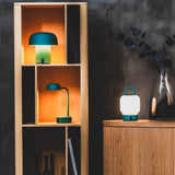 Fokus Battery Table Lamp - Smoky Teal, in a bookcase