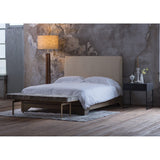 Forma Floor Lamp by Cerno with a burlap shade beside a bed