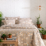 Guanabara Pendant Light by Geo Contemporary in White with copper fittings hanging in a bedroom with floral bedding