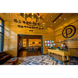 Ico Pendant Lights by Cerno lifestyle - brass cymbal pendants above a restaurant host stand