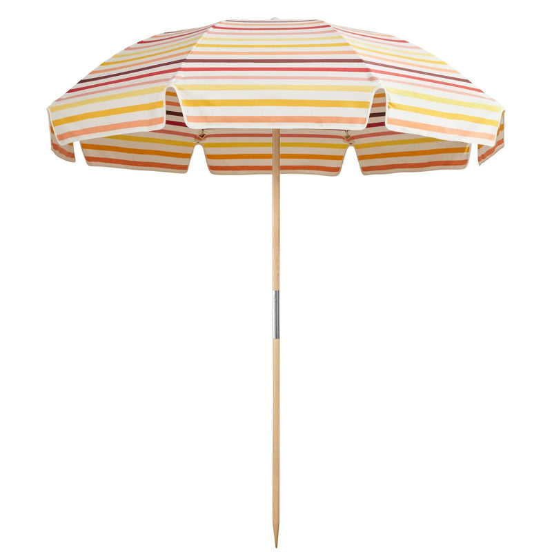 Round beach umbrella in warm multicolour stripes with a scalloped valance and pointed timber pole — Jardin Italian Umbrella 210 cm Diameter by Basil Bangs
