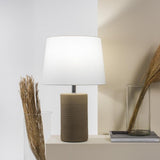 Jatobá Table Lamp by Geo Contemporary in Sand with a White shade, lit, on a console