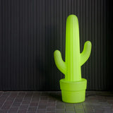 Kaktus Floor Lamp - Lime With Cable, lit against a dark wall