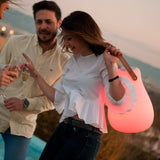 Kurby Play Portable Lamp - carried by its strap, red glow