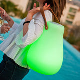 Kurby Play Portable Lamp - carried by its strap, green glow