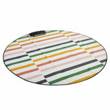 Round outdoor rug with offset multicolour stripes in coral, mustard, green and grey on cream with black trim — Love Rug by Basil Bangs