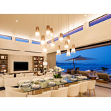 Lex Pendant Lights by Cerno clustered over a dining room with an ocean view