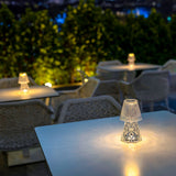 Lola Lux Table Lamp - on terrace tables at night