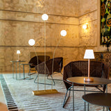 Lola Slim Portable Table Lamp - Brass, lit in a lounge