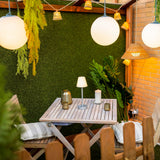 Lola Slim Portable Table Lamp - on a garden terrace table