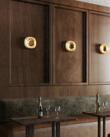 Metallic Brass Pebble Wall Sconce by Kuzco Lighting in Restaurant