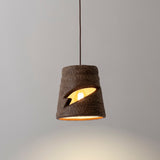 Myst Ceramic Pendant Light by Geo Contemporary in Desert, lit against a grey studio wall
