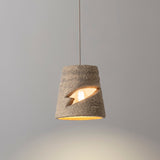 Myst Ceramic Pendant Light by Geo Contemporary in Ivory, lit against a grey studio wall
