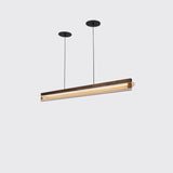 Nubis Linear Pendant by Cerno in walnut with black split canopy, lit