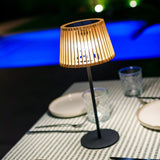Okinawa Solar Table Lamp - angled view by a pool at night