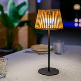 Okinawa Solar Table Lamp - lit on an outdoor dining table