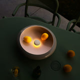 Oloha Table and Wall Lamp - Large, Desert, on a garden table