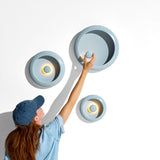 Oloha Table and Wall Lamp - Jet Blue, three sizes hung on a wall