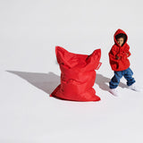 Junior Bean Bag - Red, beside a child