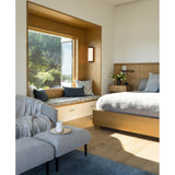 Ora Wall Sconce by Cerno beside a window seat in a bedroom