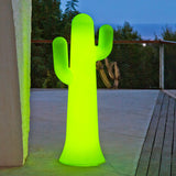 Pancho Floor Lamp - Lime With Cable, lit on a terrace