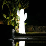 Pancho Floor Lamp - White With Cable, lit in a garden at night