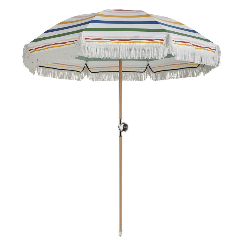 Fringed beach umbrella with multicolour rainbow stripes on a natural timber pole with a tilt joint — Premium Umbrella 180 cm Diameter by Basil Bangs