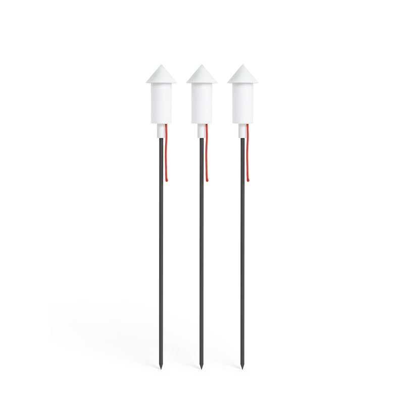Set of three white solar garden lamps with conical tops on slender black ground spikes with red cords — Pret-a-Racket Solar Floor Lamp by Fatboy